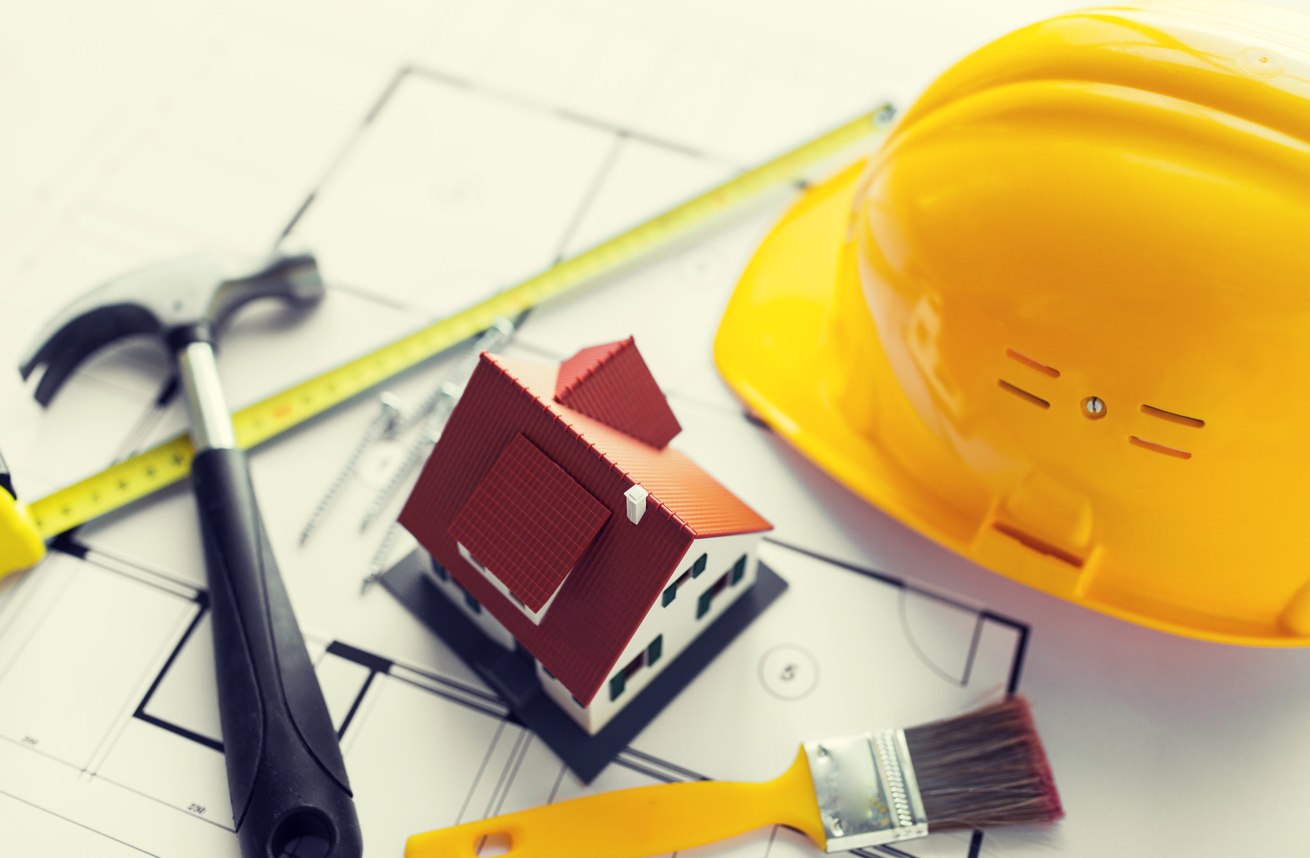 close up of house blueprint with building tools